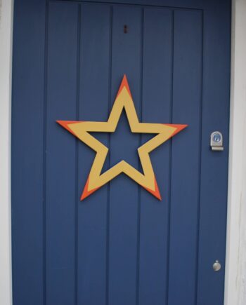Yellow, orange and blue painted wooden star wreath