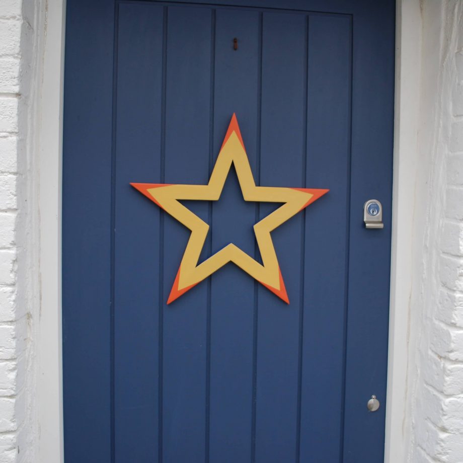 Yellow, orange and blue painted wooden star wreath