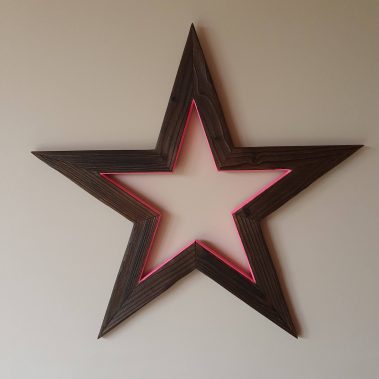 Charred wooden star wreath with neon pink highlight
