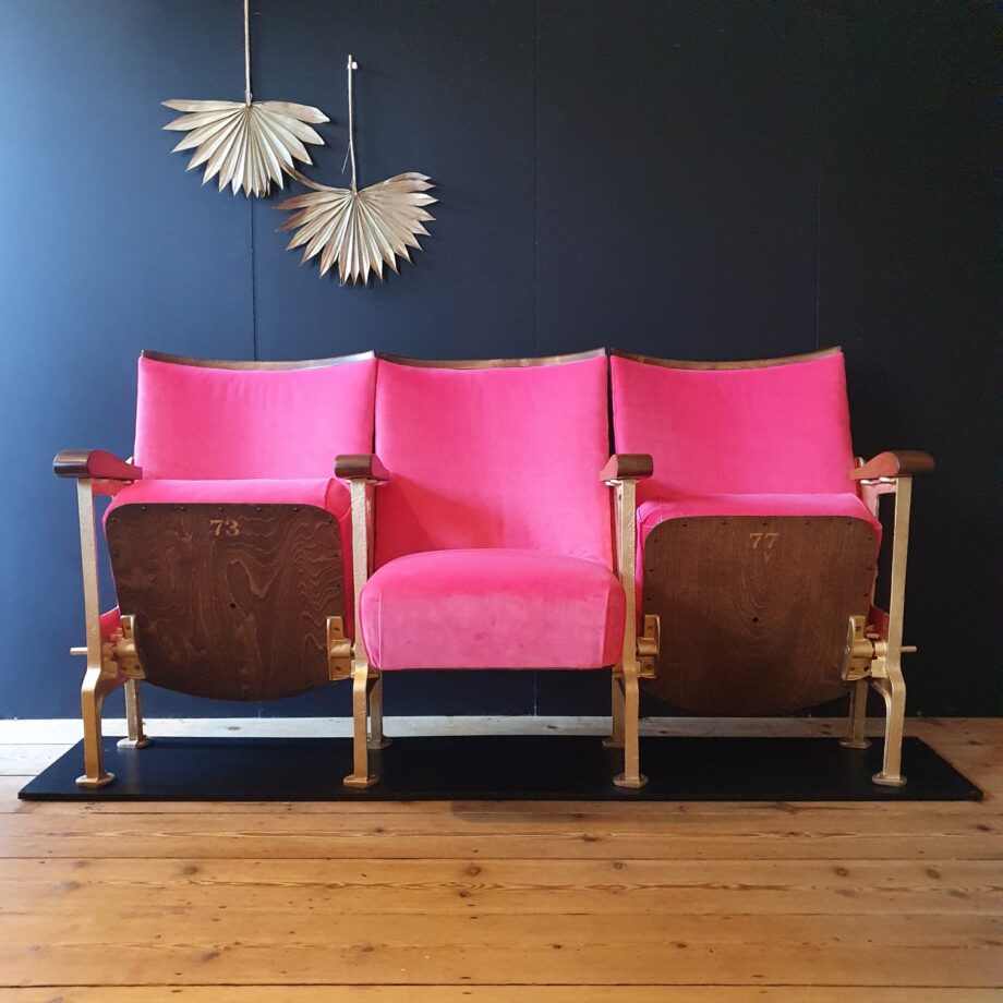 Three vintage cinema seats in a pink velvet