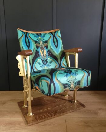 Single vintage cinema seat in a teal patterned velvet