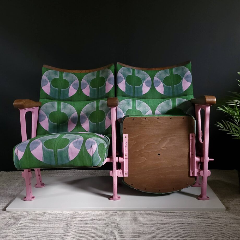 Two vintage cinema seats in pink and green velvet with pink legs