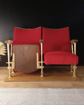 Two classic red velvet cinema seats