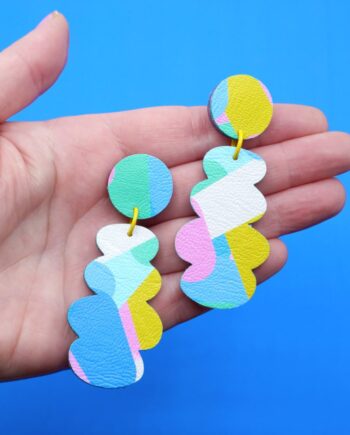 Handmade abstract dangle earrings in pastel turquoise pink, yellow and white 2ith a bold scalloped design and playful retro aesthetic