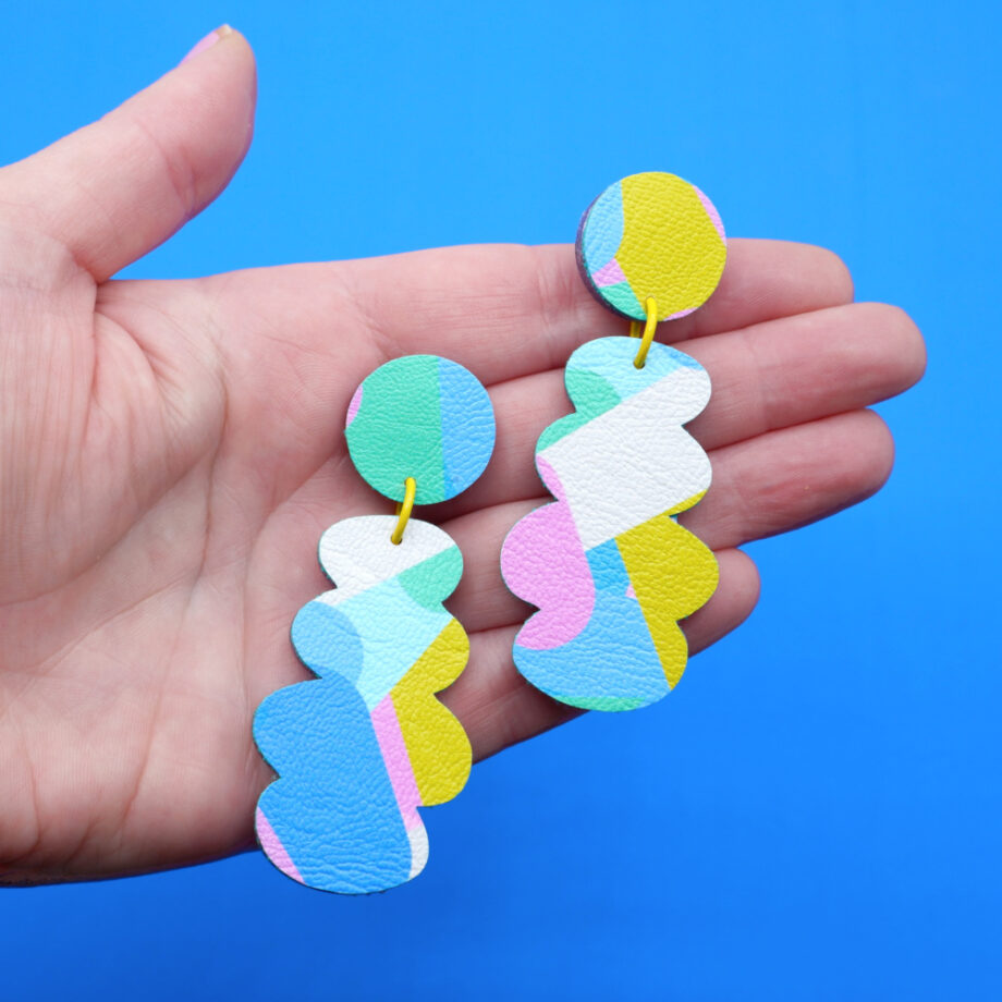 Handmade abstract dangle earrings in pastel turquoise pink, yellow and white 2ith a bold scalloped design and playful retro aesthetic