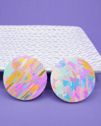 Unique, colourful round stud earrings featuring a pastel multicoloured painterly design.