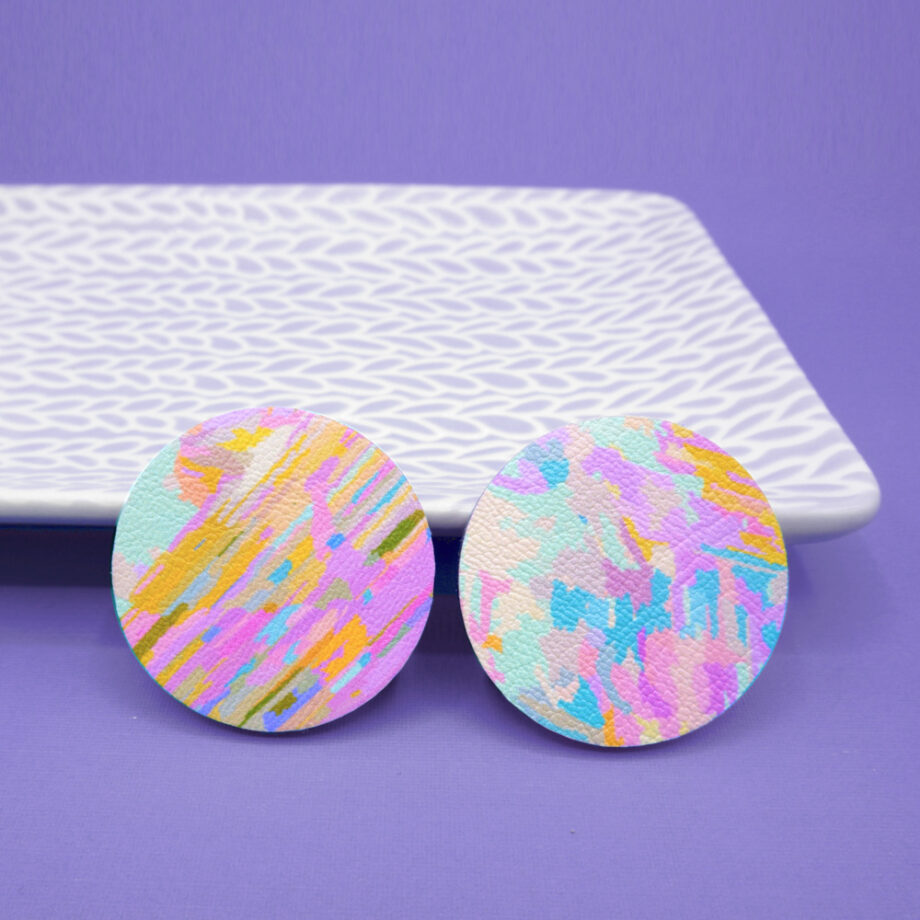 Unique, colourful round stud earrings featuring a pastel multicoloured painterly design.