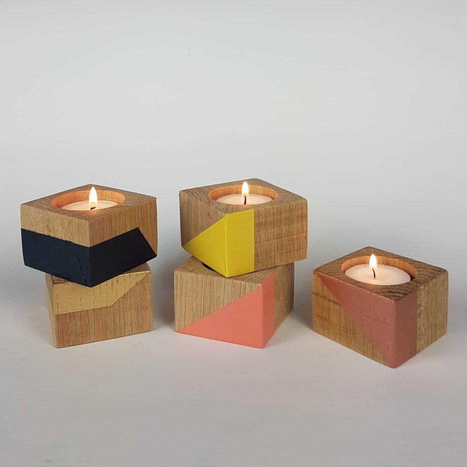 Group of small wooden candle cubes colourful display
