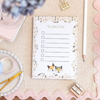 A6 To Do List Notepad, featuring 2 cute foxes dressed for fun, the edges of the notepad feature a crackle colour design