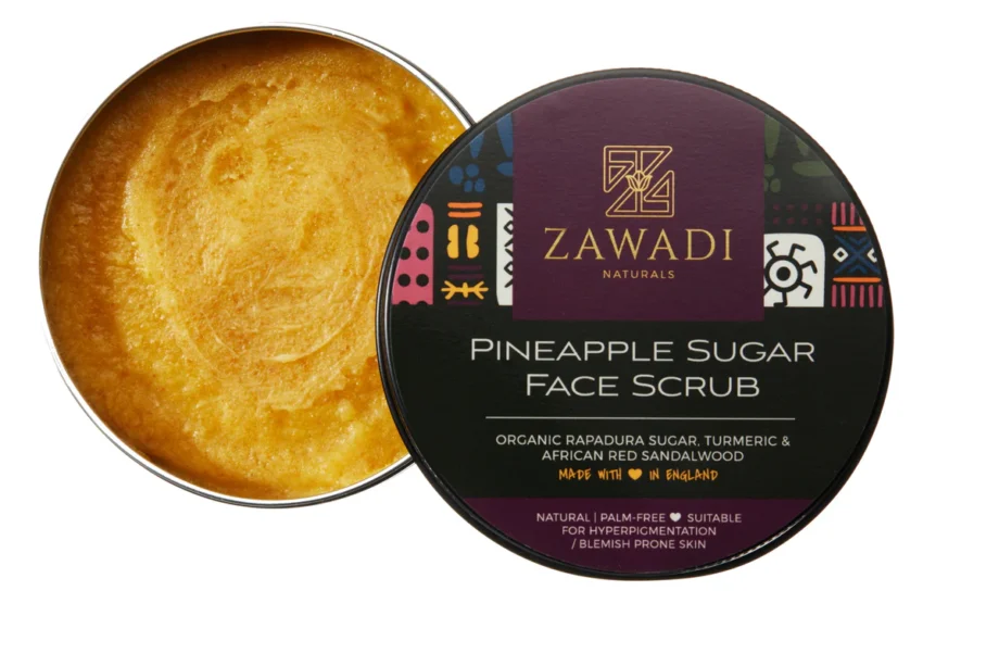 Open jar of Pineapple, Camwood & Turmeric Sugar Scrub showing rich texture and golden hue