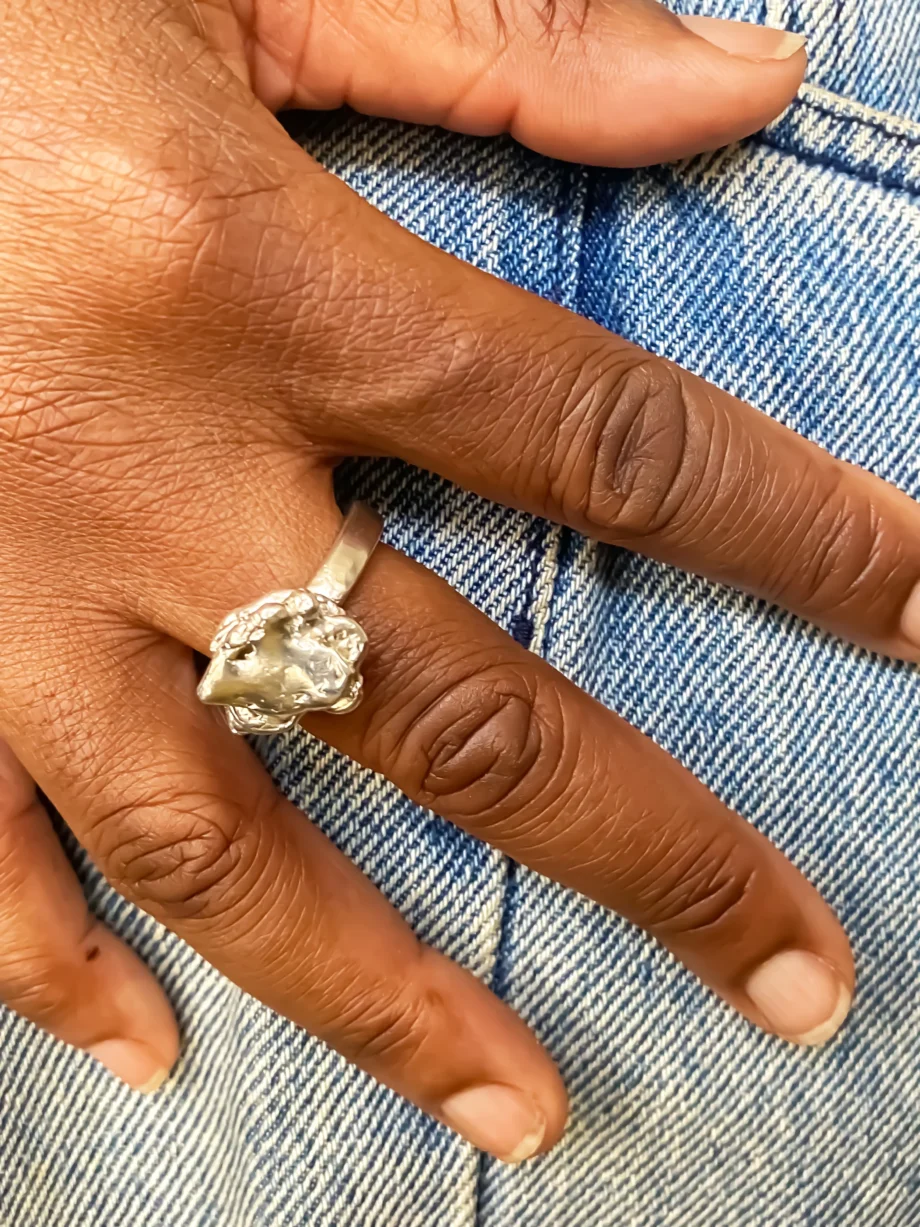 Hand wearing handcrafted sterling silver flower ring by MOCA Jewellery