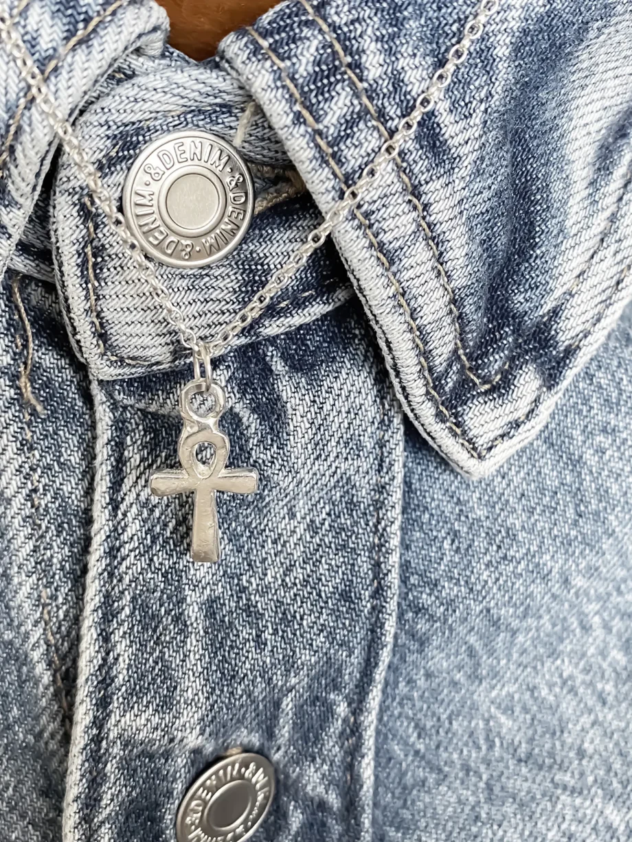 Silver Ankh Pendant clipped to denim jacket buttonhole