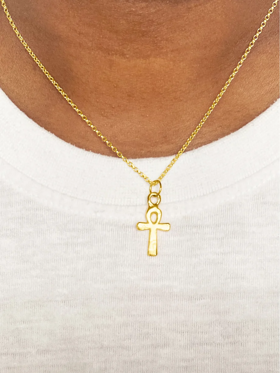 Gold Ankh Pendant worn on model with white top