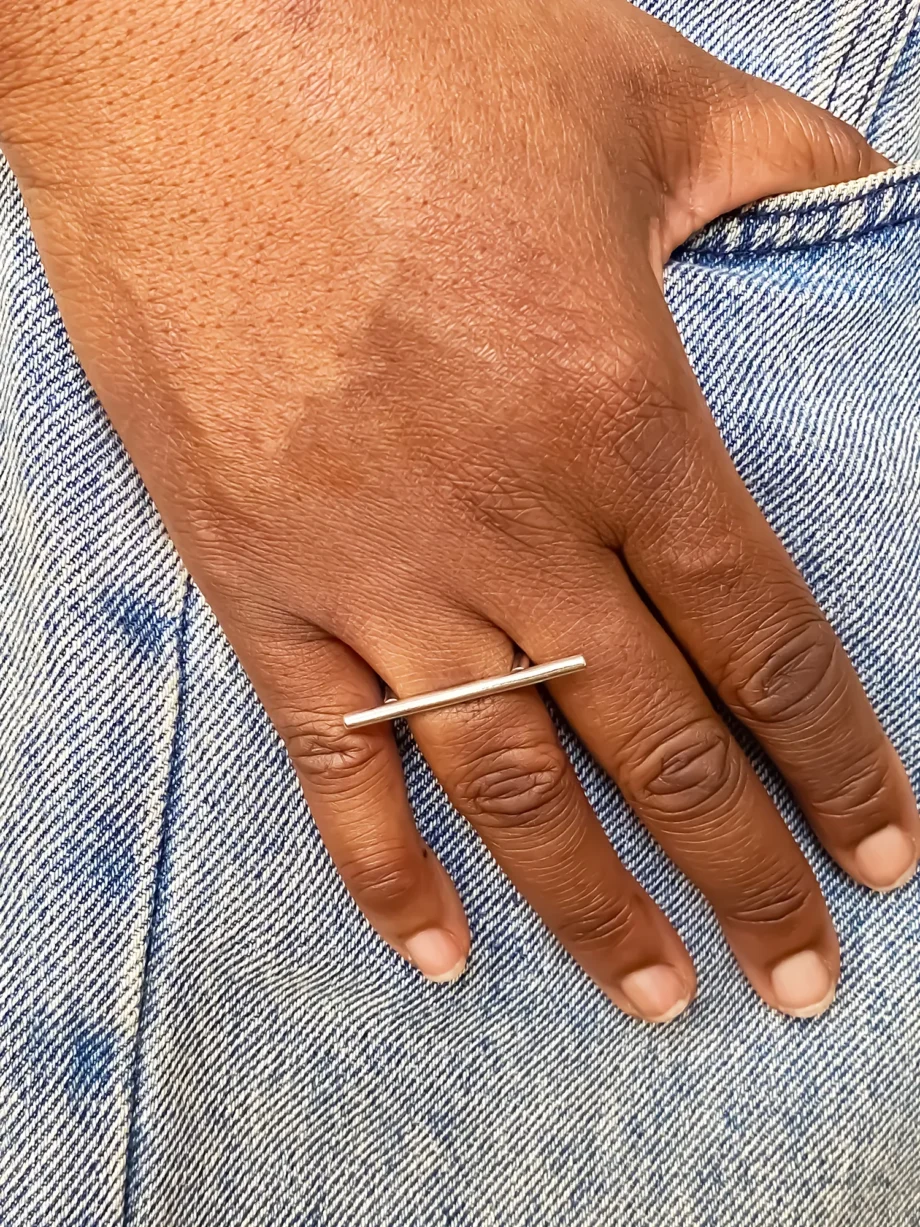 Hand wearing the Sculpted Bar Ring in sterling silver on index finger.