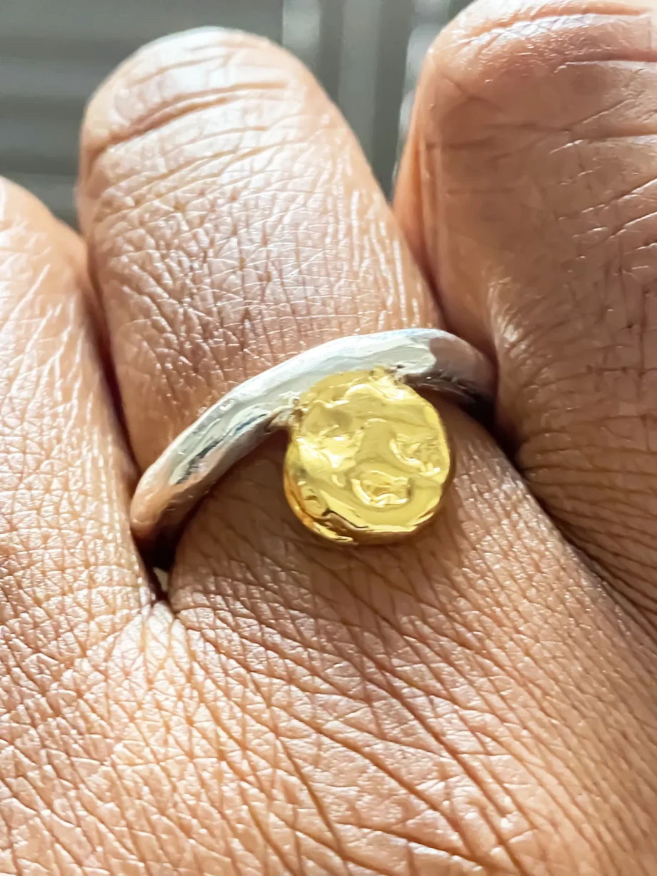 Close-up of the Circle Accent Ring on hand, showing detailed texture