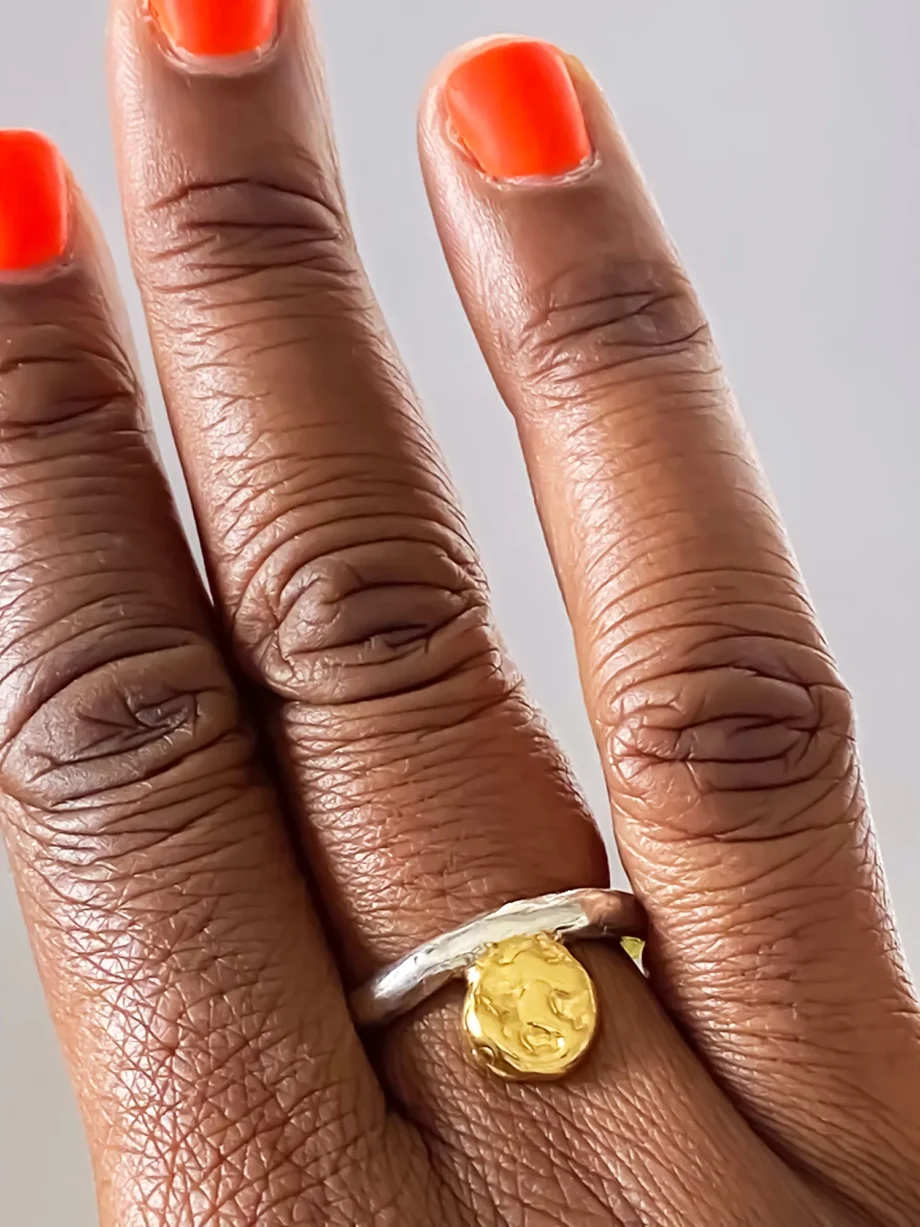 Hand wearing the Circle Accent Ring in silver with gold accent on two fingers