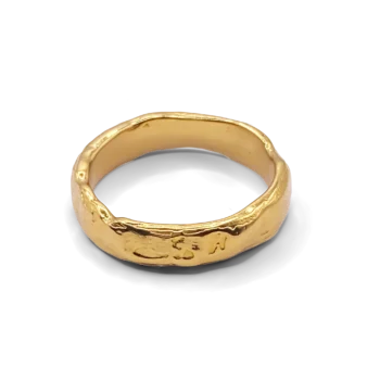 Textured gold ring on white background
