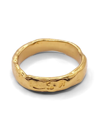 Textured gold ring on white background