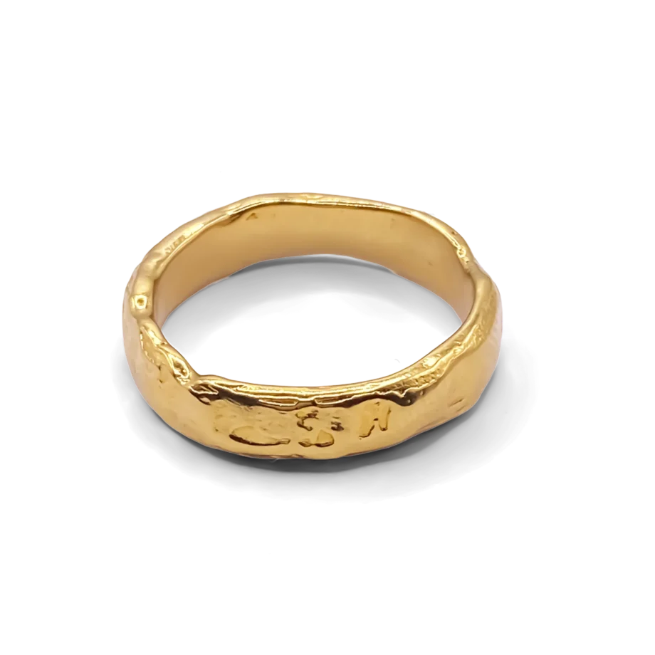 Textured gold ring on white background