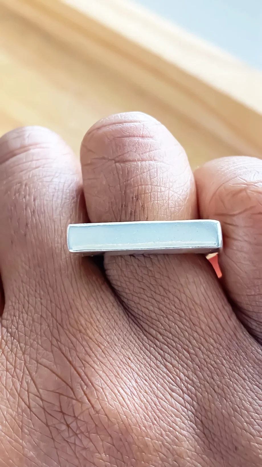 Flat ring worn on hand, top view of rectangular face