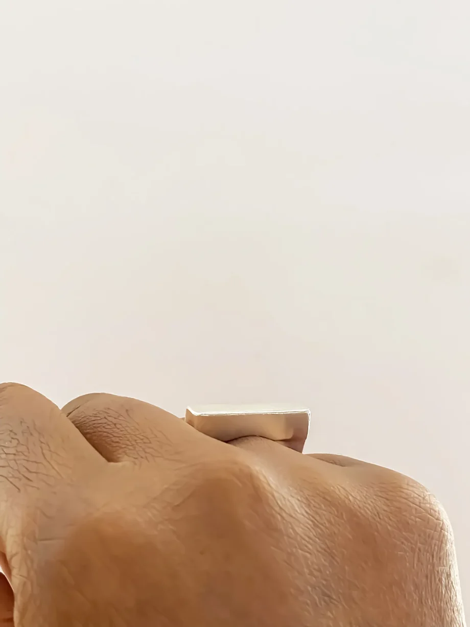 Flat ring worn on hand, side view