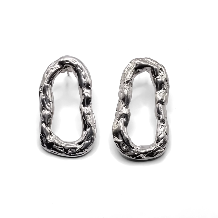 Pair of silver Flow Loop Earrings on white background, showing organic surface detail