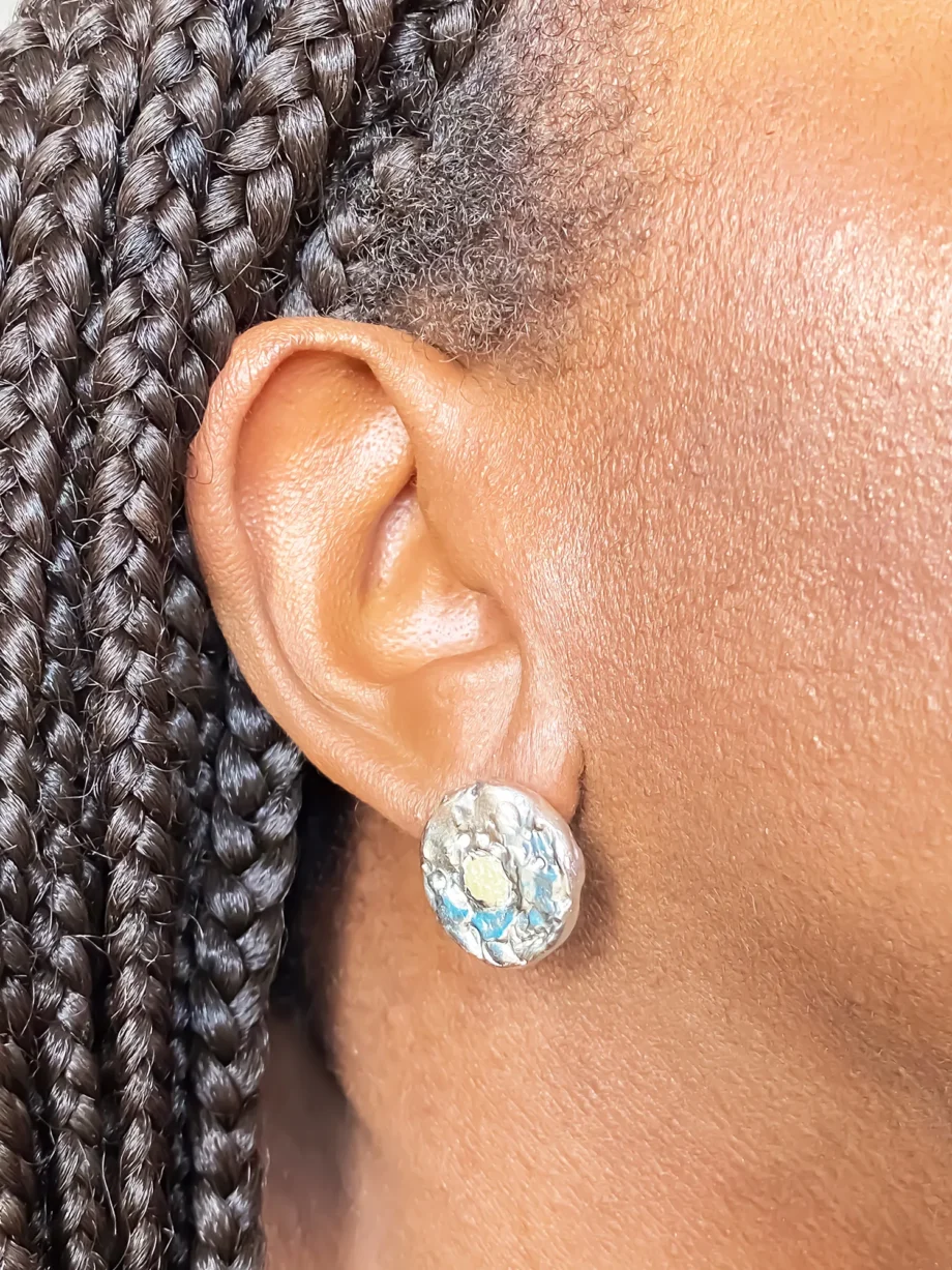 Close-up of Grain Circle Stud Earring worn on ear, front view