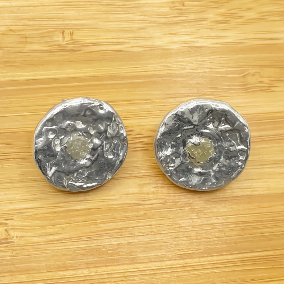 Grain Circle Stud Earrings in sterling silver displayed on wooden background