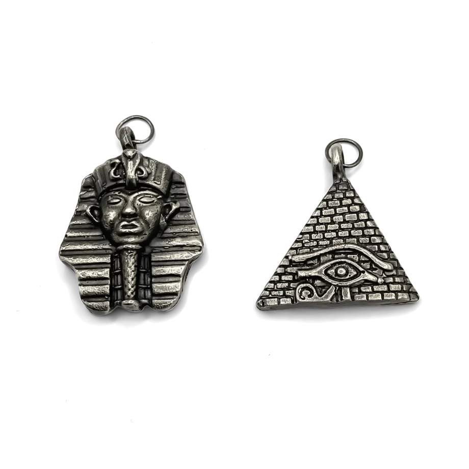 Pharaoh head and pyramid eye pendants in oxidised silver finish, side by side.