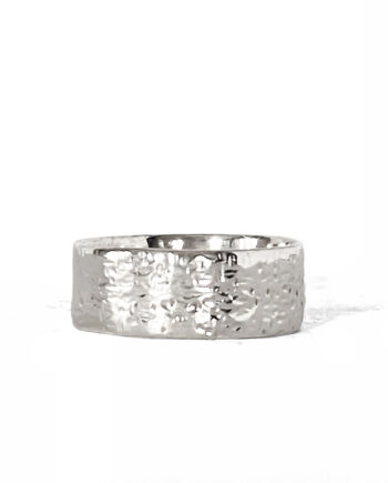 Hammered silver ring photographed on a white background, angled to show texture.