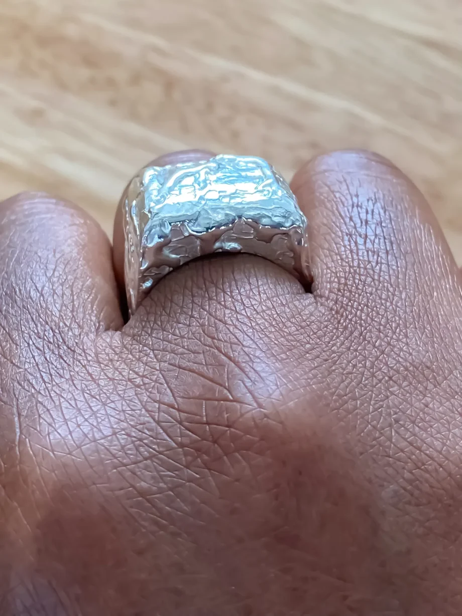 Front view of silver Textured Signet Ring worn on hand