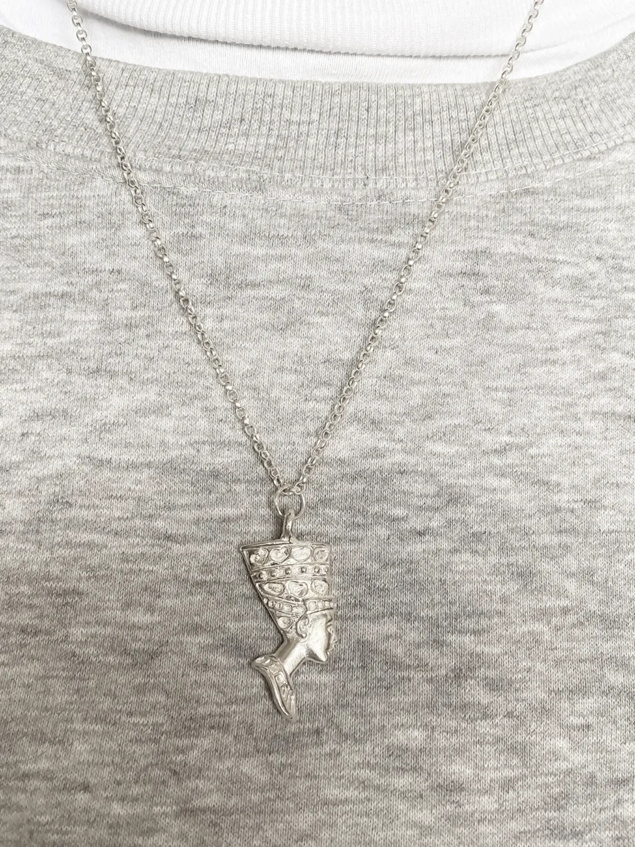 Nefertiti face necklace in sterling silver worn over a grey jumper