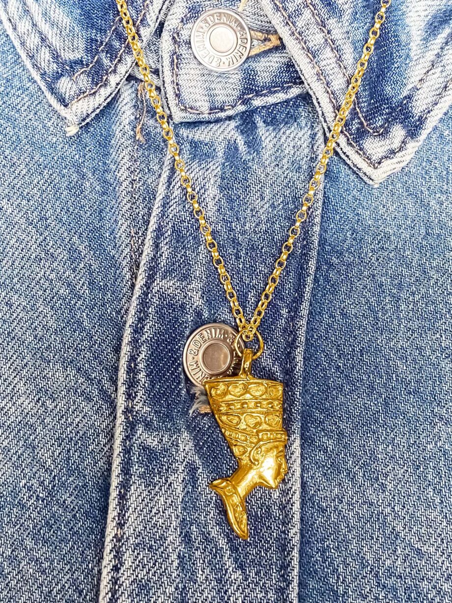 Gold Nefertiti necklace worn with a denim jacket
