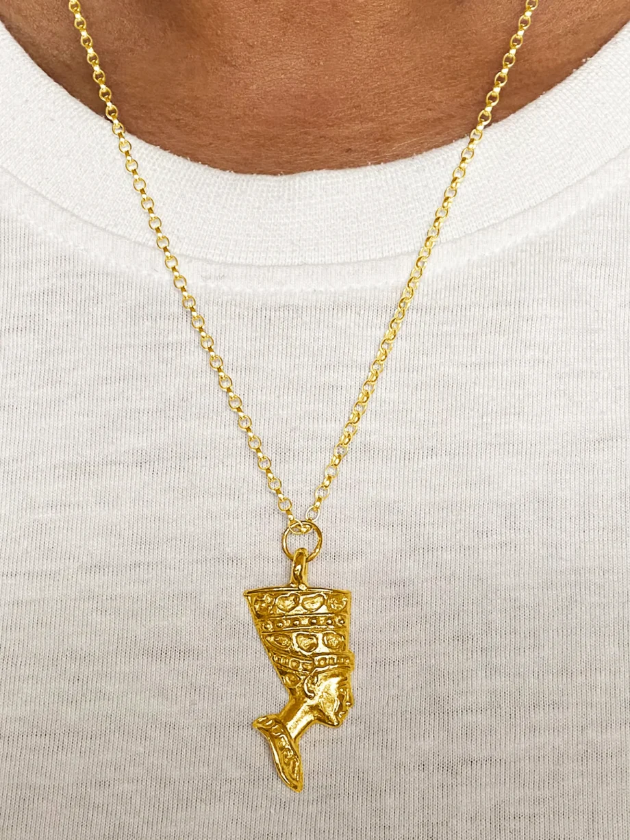 Gold Nefertiti necklace over a white top