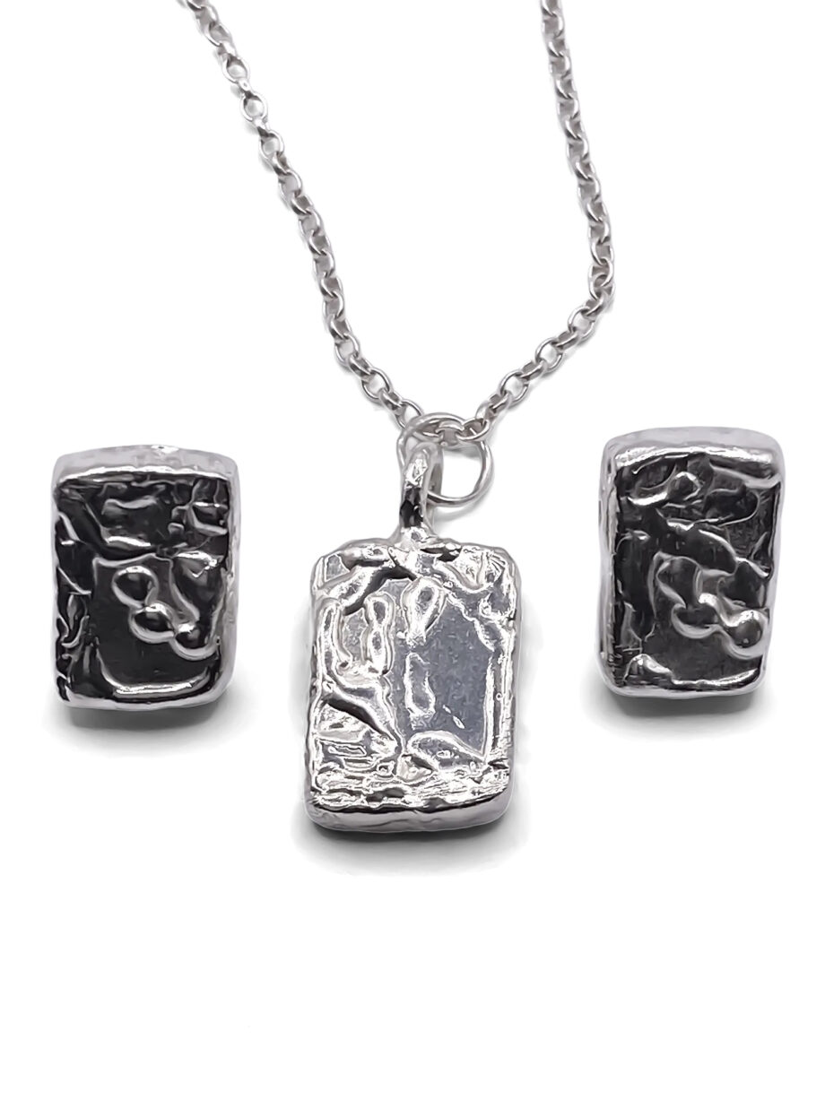 Rectangular sculpted silver earrings and matching pendant on chain, displayed on a white background