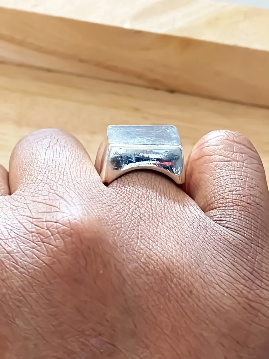Close-up of silver square signet ring worn on finger from different perspectives