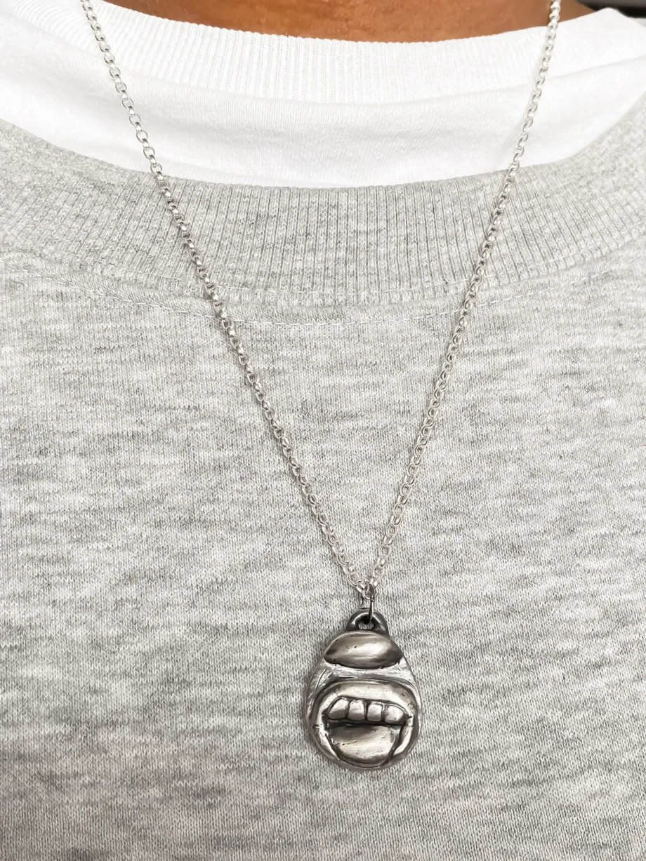 Tongue & Teeth Pendant worn with light grey knit top