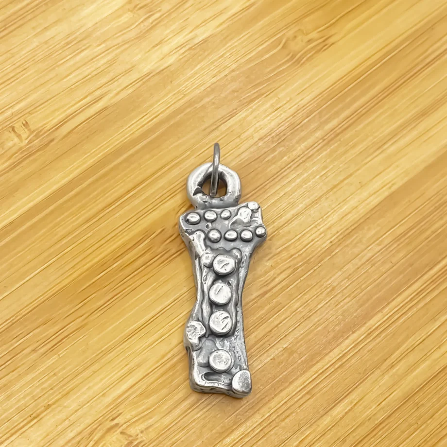 Twig Pendant photographed on wooden background