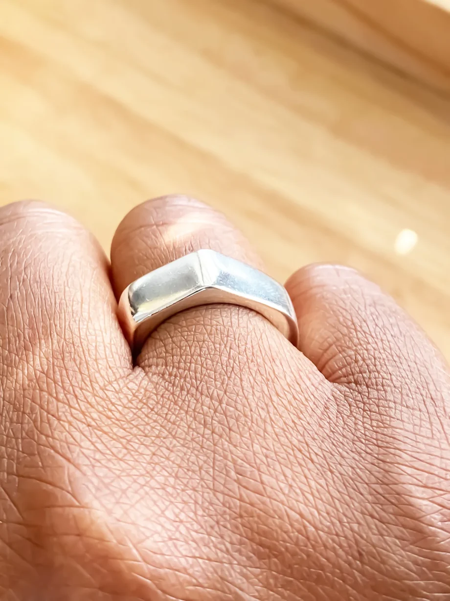 Close-up of the Wonky Nut Ring worn on hand, angled view