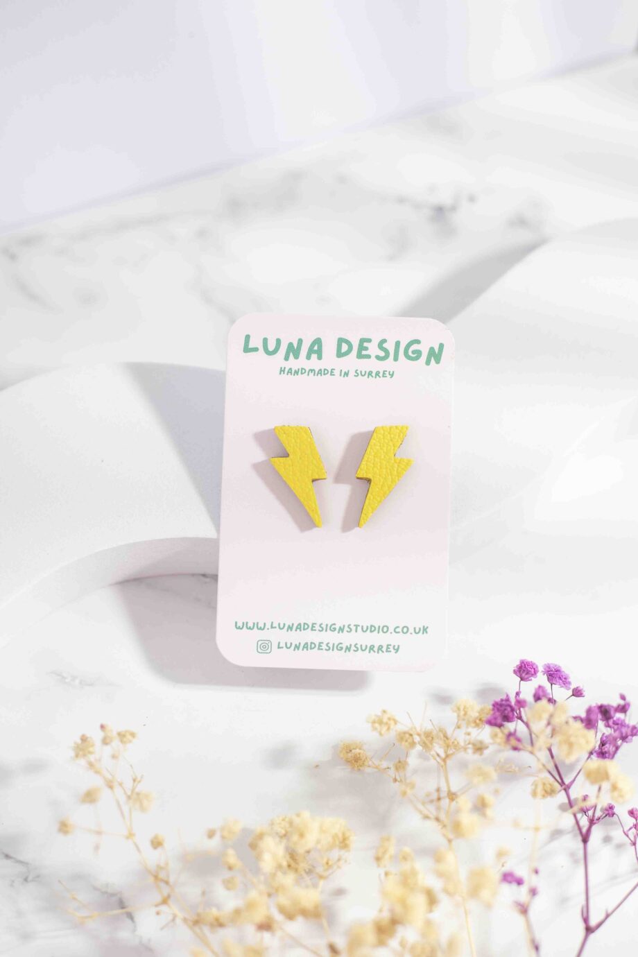 Small lightning bolt-shaped stud earrings made from yellow leather