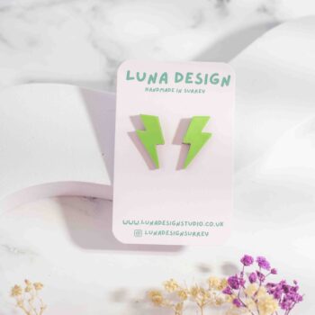 Lime green lightning bolt stud earrings with a glossy patent finish