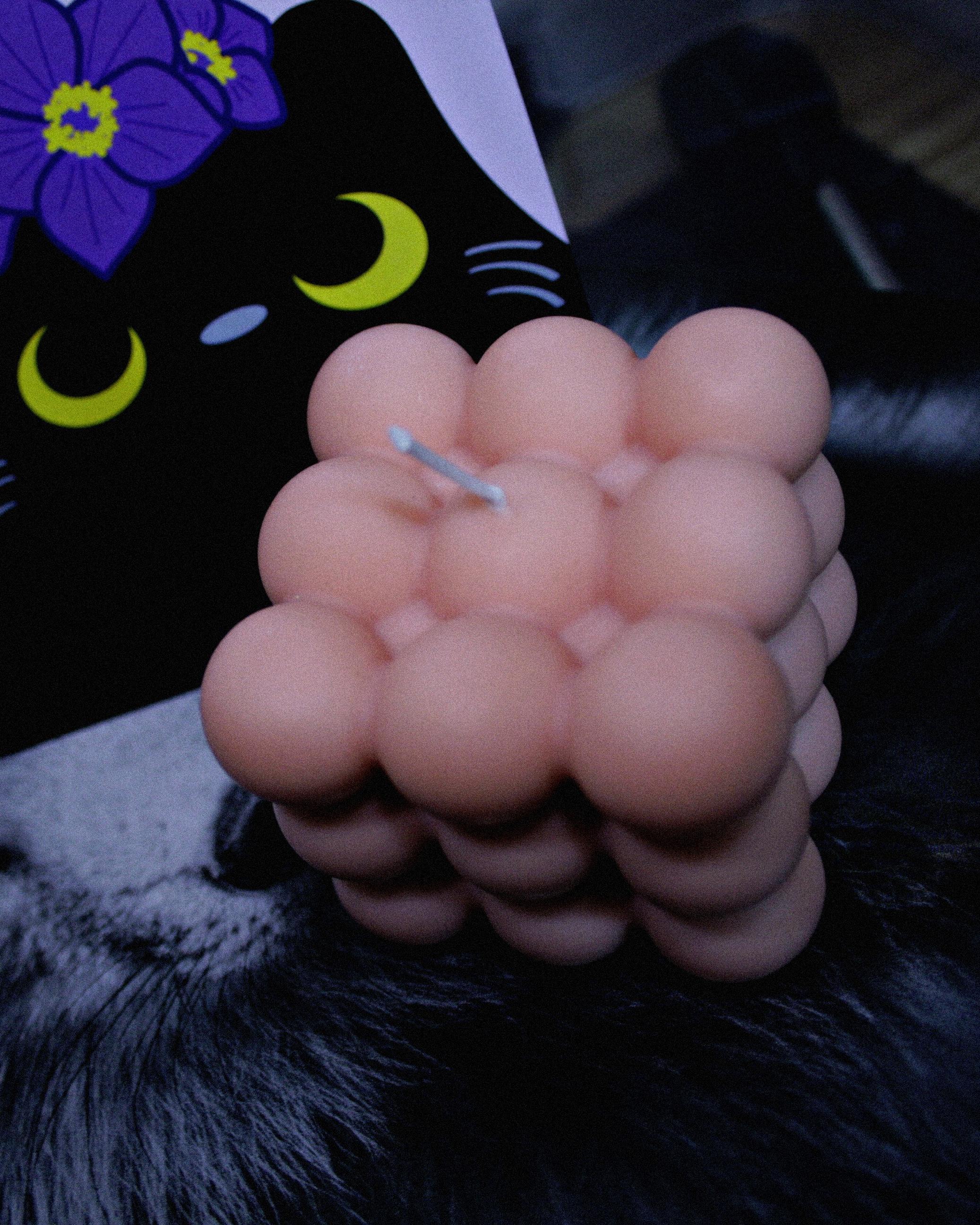 Light pink Lavender scented bubble candle with a postcard with a black cat in the background