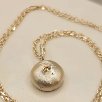 Molten Silver Pebble Pendant with Yellow Sapphire